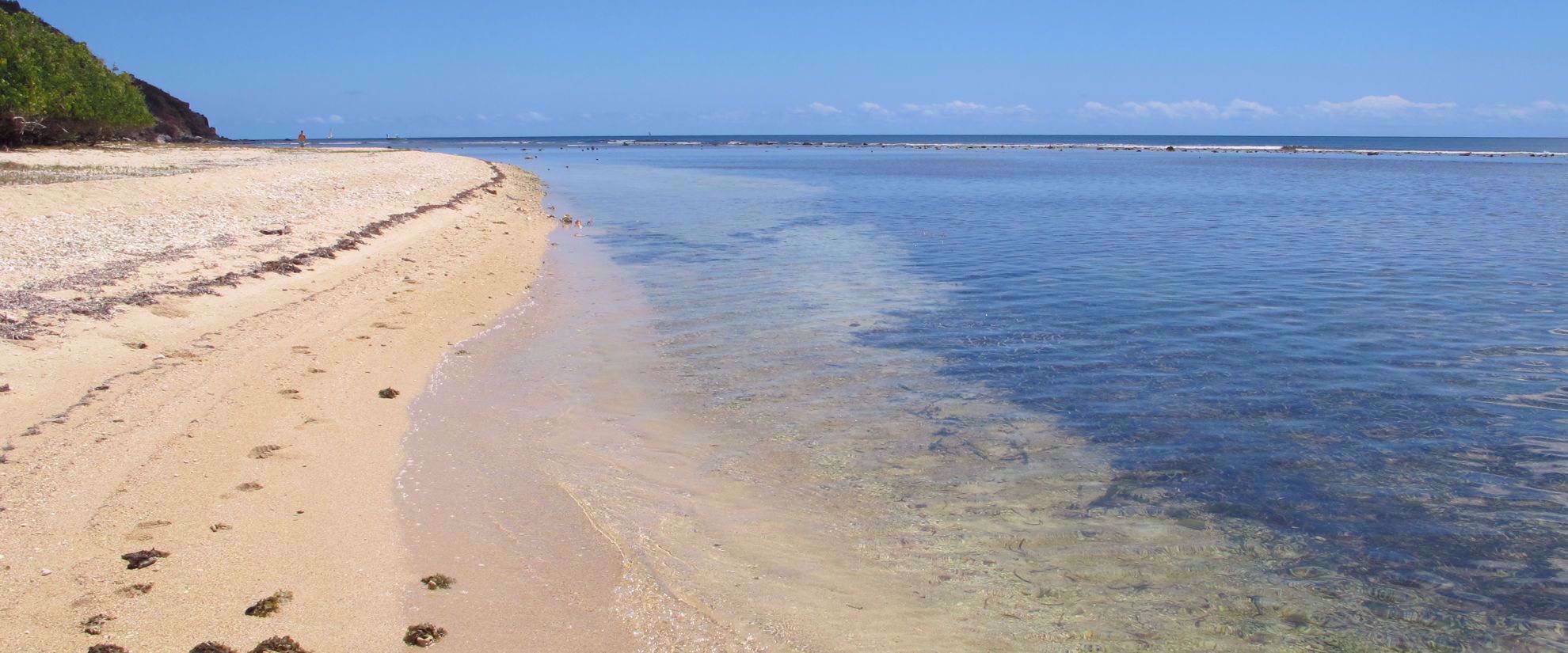 Sunny caribbean coastline on empty beach