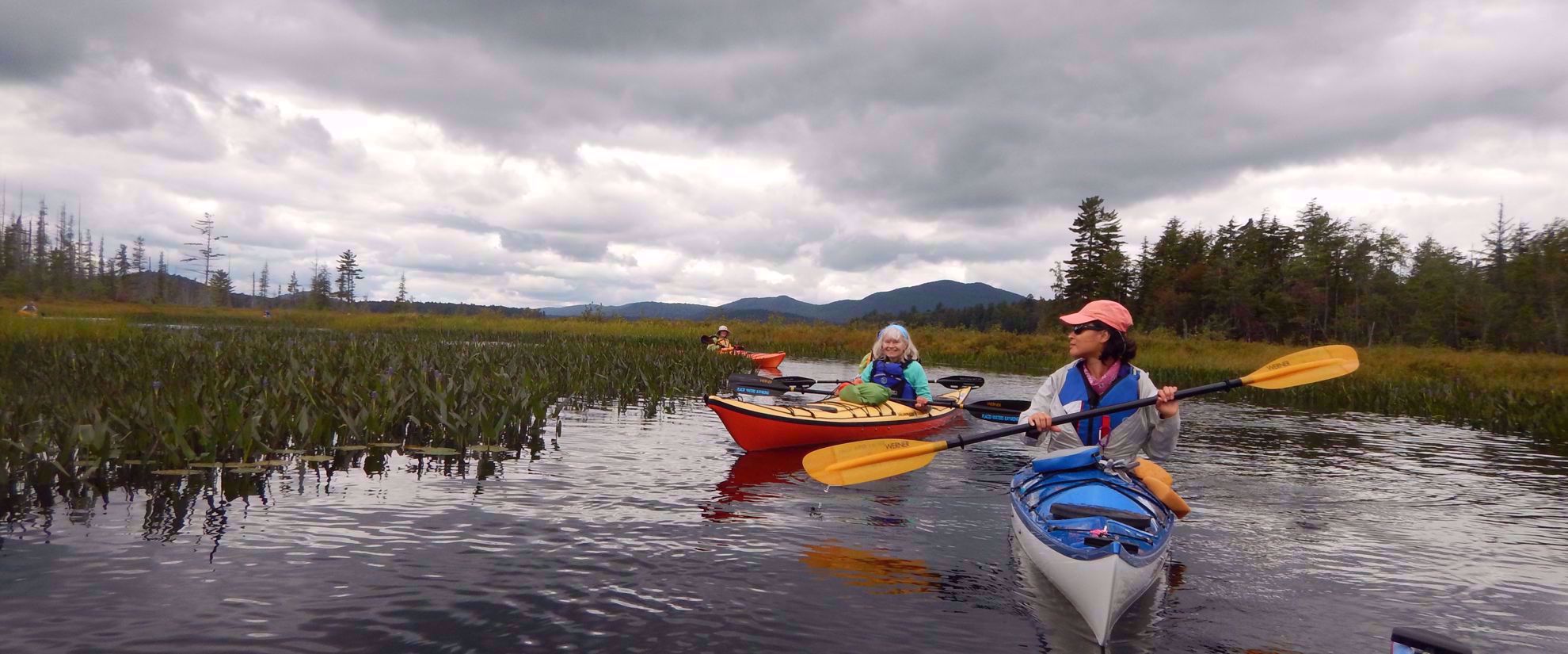 women's tour group kayaking in the adirondacks