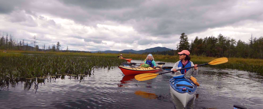 women's tour group kayaking in the adirondacks