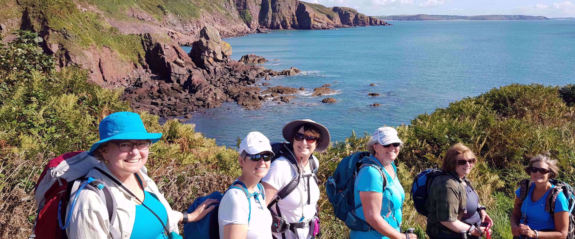 Picture of Hiking Wales women smile for group photo while hiking whales