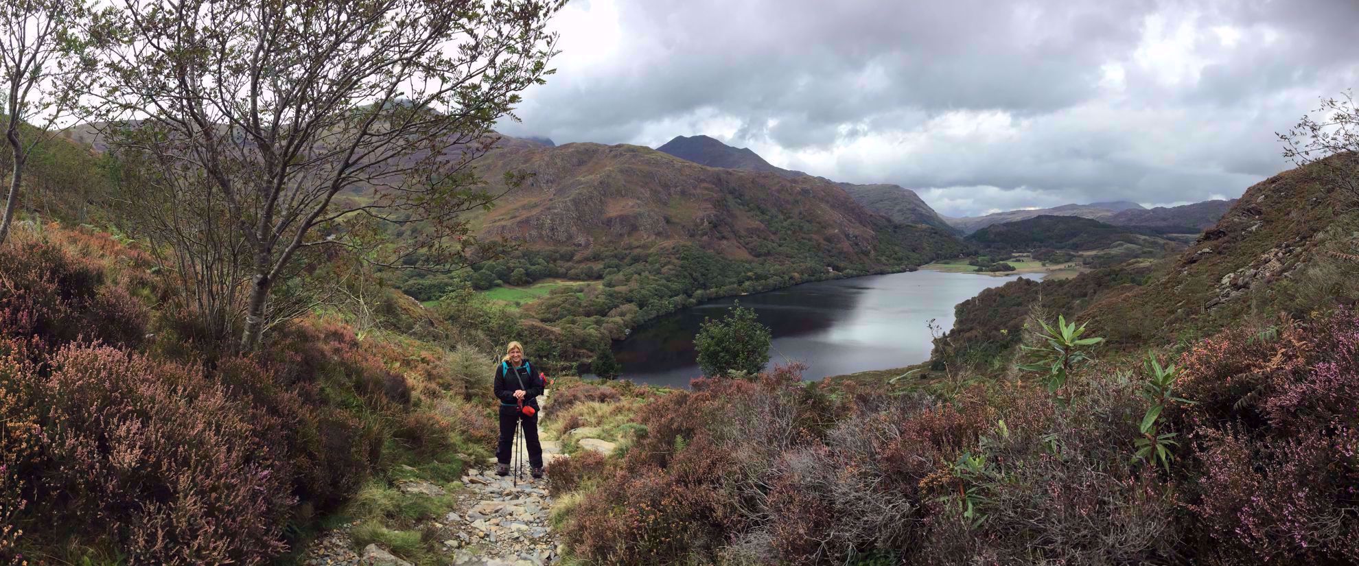 Picture of Hiking Wales woman smiles on hike by lake in whales