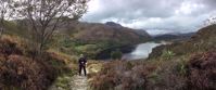 Picture of Hiking Wales woman smiles on hike by lake in whales