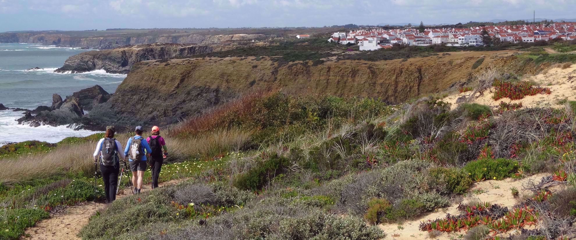 three women hiking along portugal coast