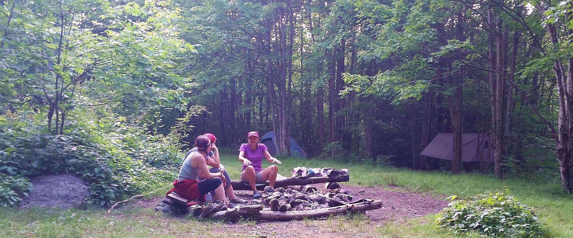 women chatting around campfire appalachian trail