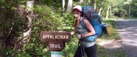 Picture of Intro to Lightweight Backpacking on the AT woman smiles by appalachian trail sign