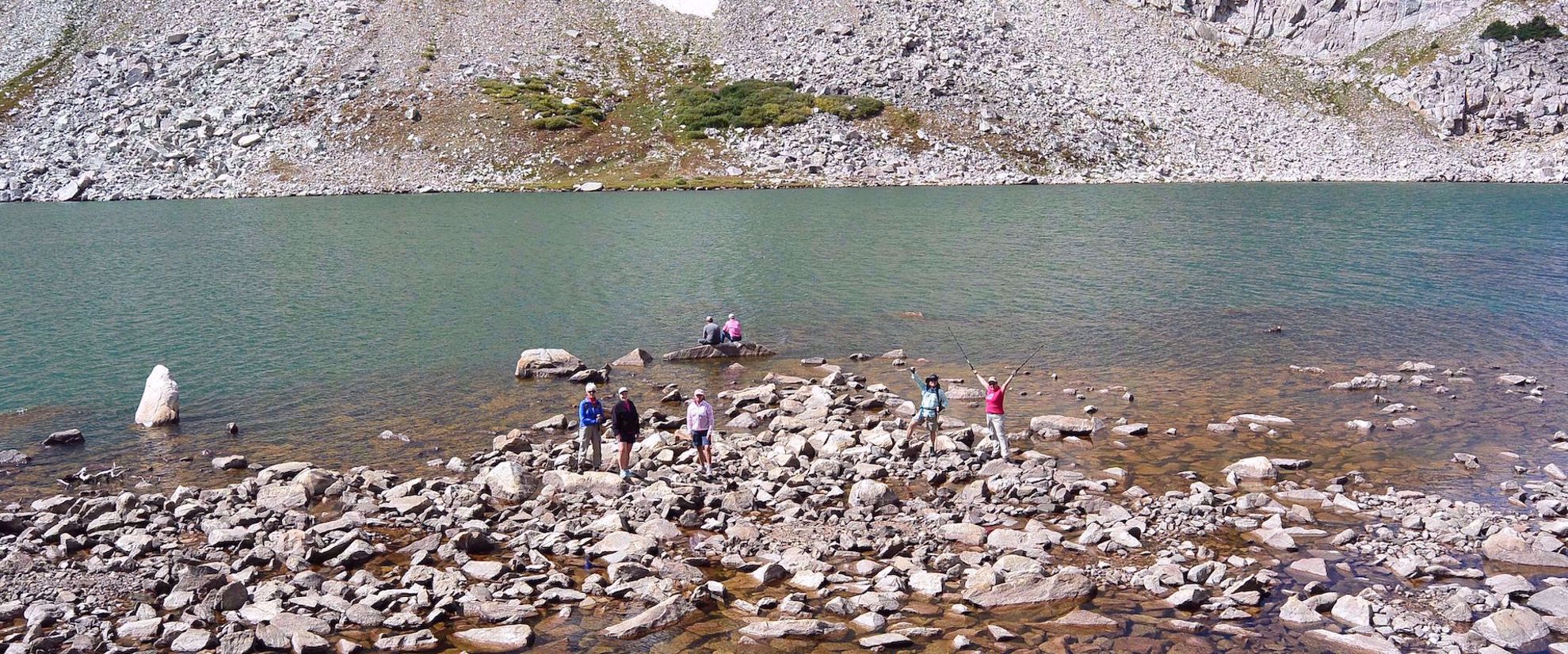 Women hikers at an alpine lake in the Snowy Mountains Picture of Alpine Hiking in the Snowy Range